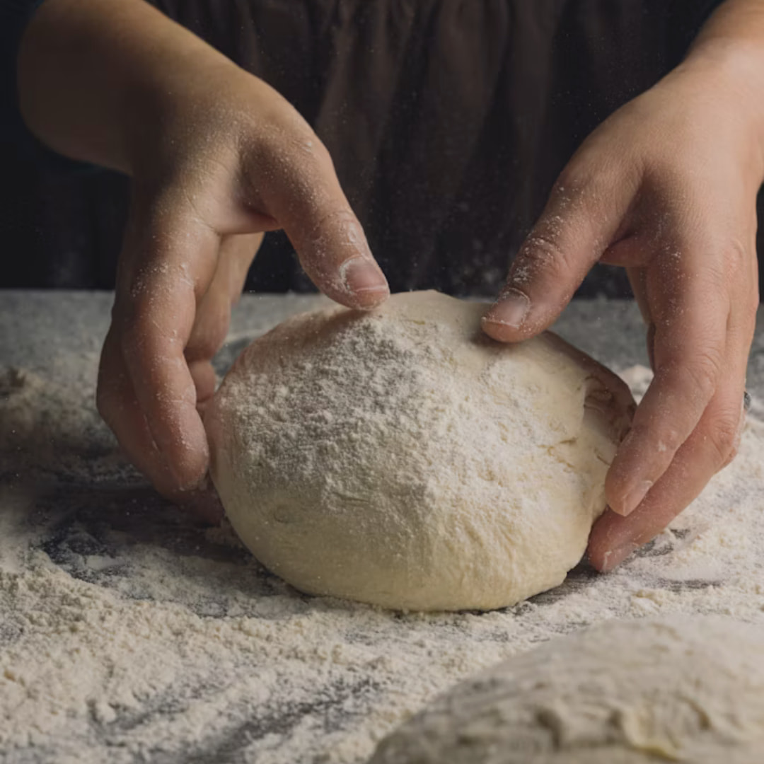Hands shaping fresh dough at CrumbStudio